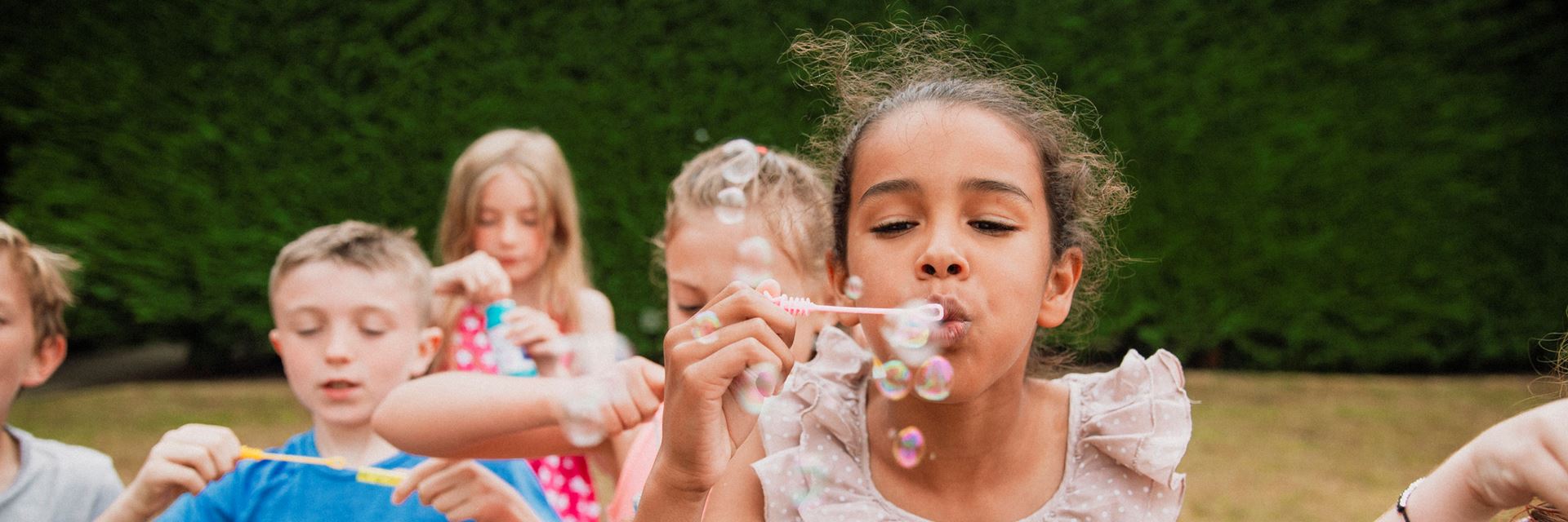 foster children blowing bubbles