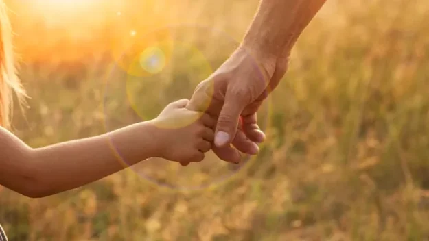 Child Holds Parent's Hand